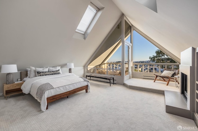 carpeted bedroom featuring vaulted ceiling with skylight, access to outside, and baseboard heating