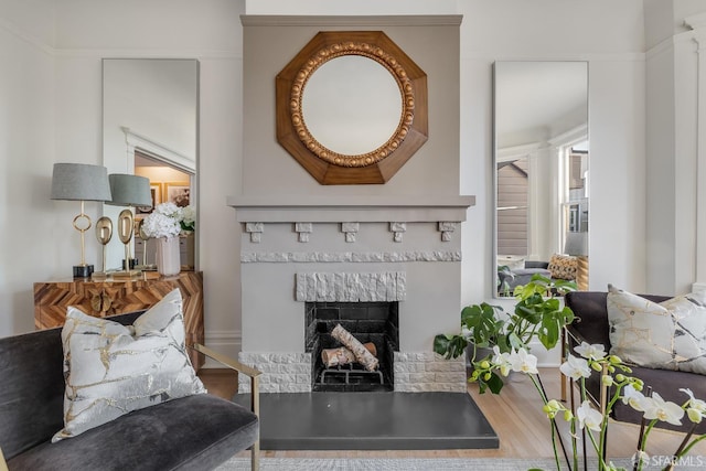 living area featuring a fireplace and wood finished floors