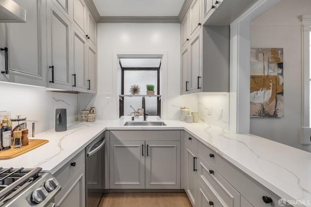 kitchen with light stone countertops, gray cabinets, and a sink