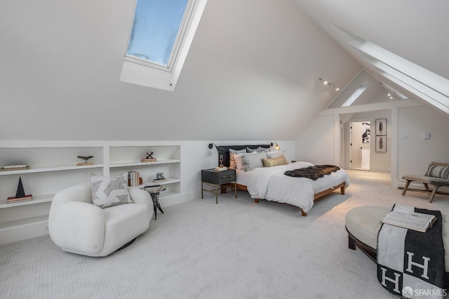 bedroom featuring lofted ceiling with skylight and carpet