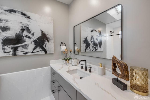 bathroom featuring a skylight and vanity