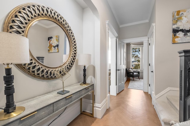 corridor with ornamental molding and baseboards