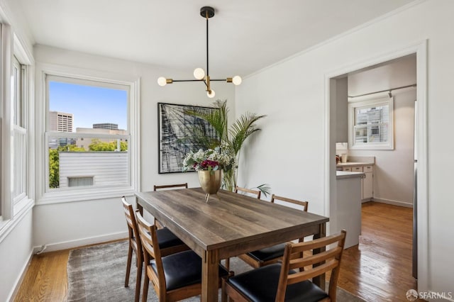 221 Lily St, San Francisco, CA 94102 - dining space featuring a chandelier, wood finished floors, and baseboards