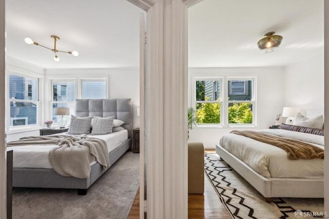 221 Lily St, San Francisco, CA 94102 - bedroom with wood finished floors and a chandelier