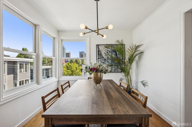 221 Lily St, San Francisco, CA 94102 - dining space featuring a chandelier, wood finished floors, and baseboards