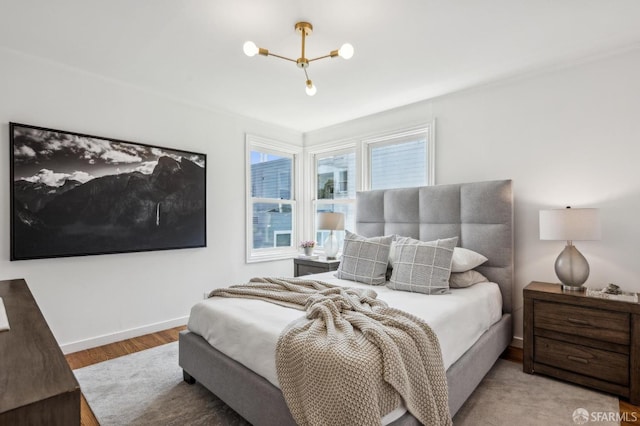 221 Lily St, San Francisco, CA 94102 - bedroom with wood finished floors, baseboards, and a chandelier