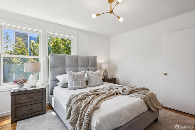 221 Lily St, San Francisco, CA 94102 - bedroom featuring a chandelier, wood finished floors, and baseboards