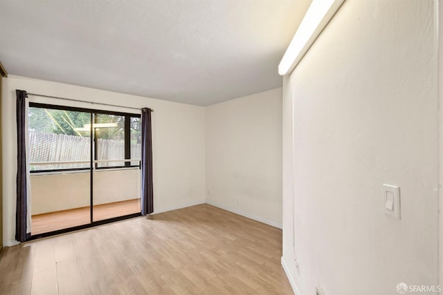 unfurnished room featuring light wood-style flooring and baseboards