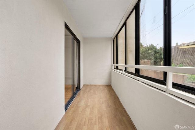 corridor with light wood-type flooring