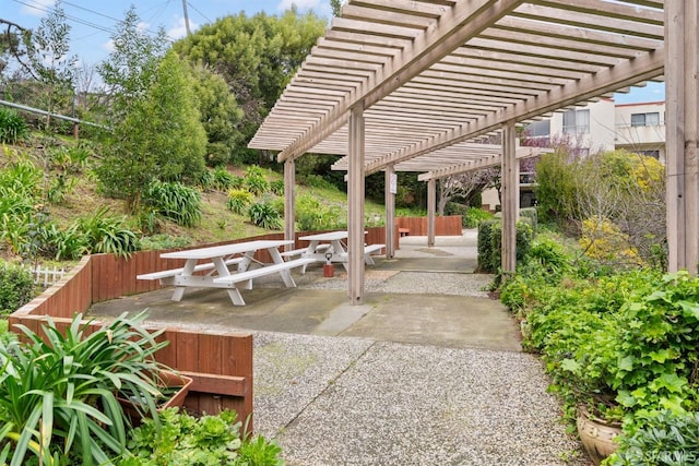 view of patio / terrace featuring outdoor dining space, fence, and a pergola