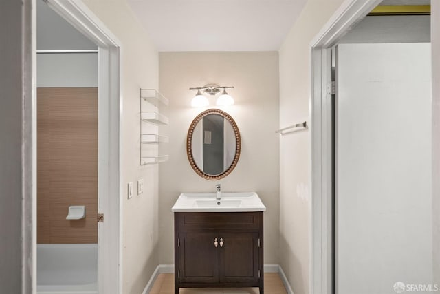 bathroom featuring baseboards and vanity