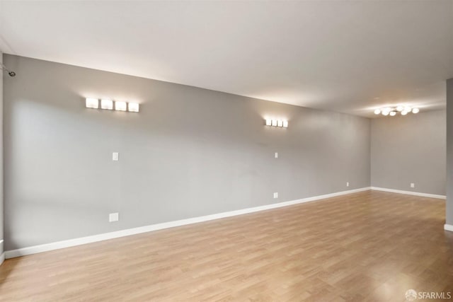 empty room with light wood-style floors and baseboards