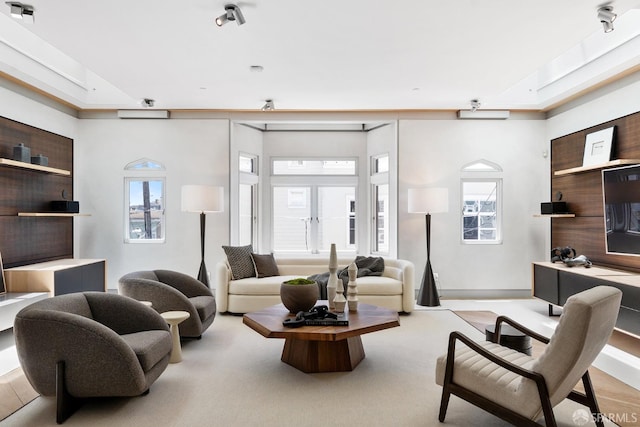 living room featuring a high ceiling and light wood-type flooring