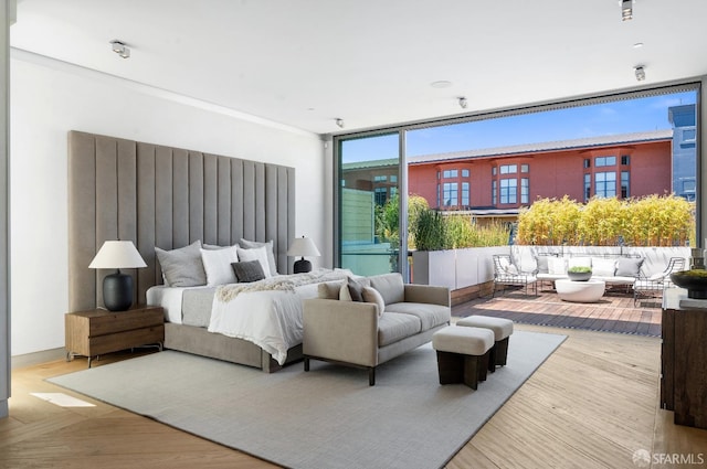 bedroom featuring light hardwood / wood-style flooring and multiple windows