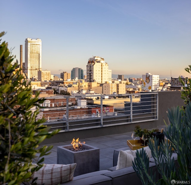 balcony featuring a city view and a fire pit