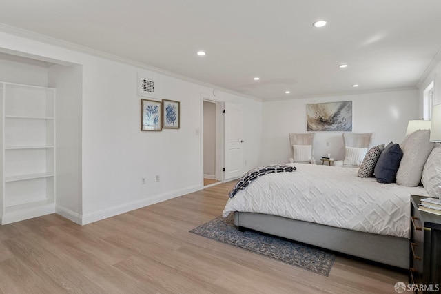 bedroom with ornamental molding and light wood-type flooring