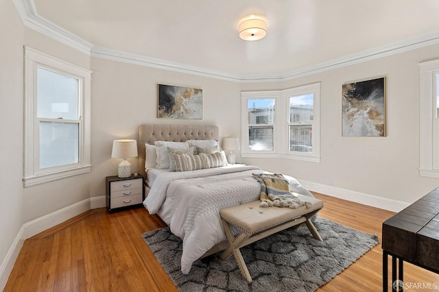 bedroom featuring hardwood / wood-style flooring and ornamental molding