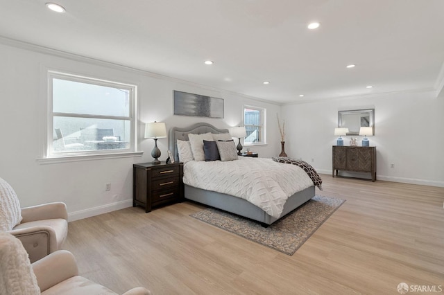 bedroom featuring crown molding and light wood-type flooring