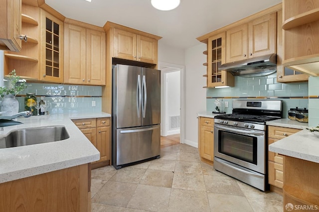 kitchen with sink, backsplash, light brown cabinets, and appliances with stainless steel finishes