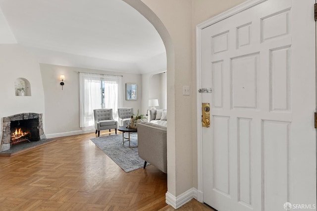 entryway featuring light parquet flooring and a fireplace