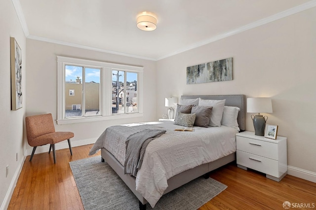 bedroom featuring wood-type flooring and ornamental molding