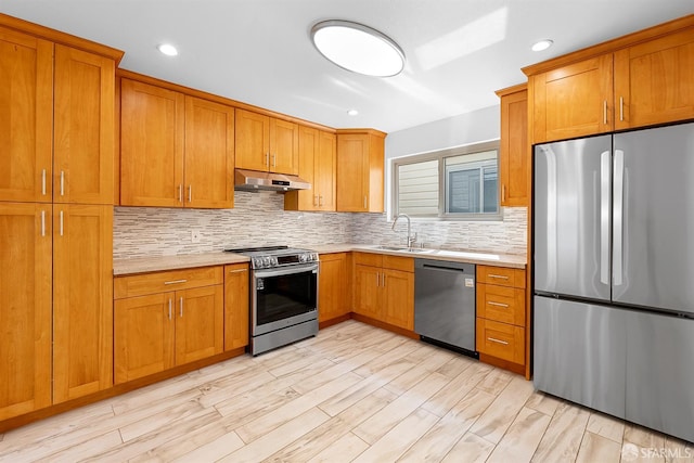 341 Prentiss St, San Francisco, CA 94110 - kitchen featuring stainless steel appliances, under cabinet range hood, light countertops, brown cabinetry, and recessed lighting