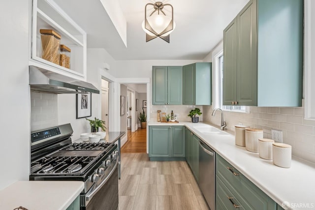1371-1373 16th Ave, San Francisco, CA 94122 - kitchen featuring green cabinetry, stainless steel appliances, ventilation hood, and light countertops