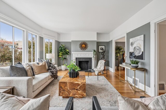 1371-1373 16th Ave, San Francisco, CA 94122 - living room featuring wood finished floors and a brick fireplace