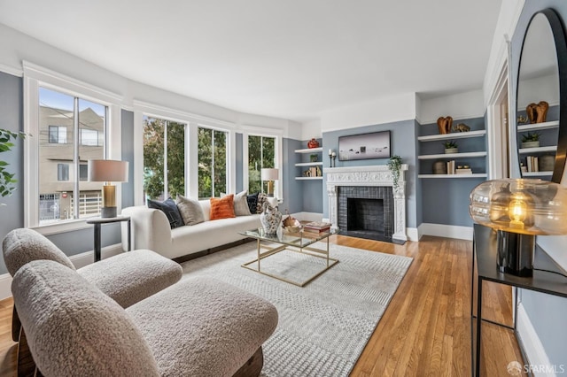 1371-1373 16th Ave, San Francisco, CA 94122 - living room with a tile fireplace, wood finished floors, and built in shelves