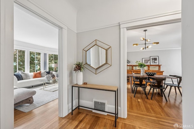 1371-1373 16th Ave, San Francisco, CA 94122 - hallway with wood finished floors, a chandelier, and crown molding