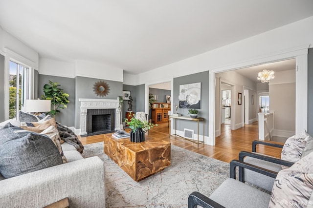 1371-1373 16th Ave, San Francisco, CA 94122 - living room featuring wood finished floors, a chandelier, and a brick fireplace