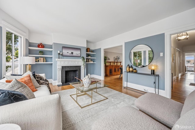 1371-1373 16th Ave, San Francisco, CA 94122 - living room featuring healthy amount of natural light, a fireplace, wood finished floors, and built in features