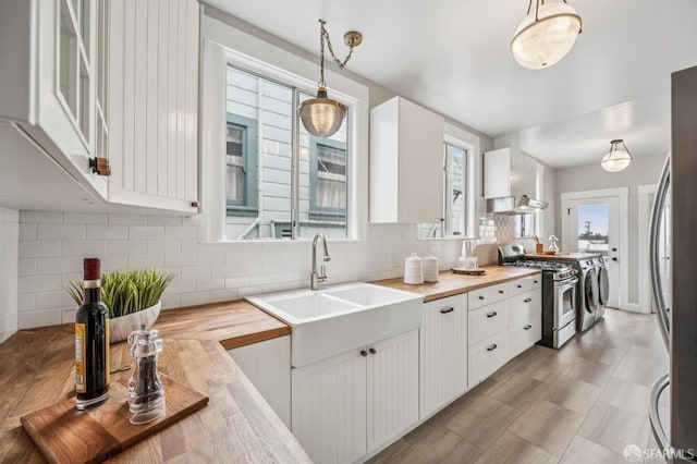 1371-1373 16th Ave, San Francisco, CA 94122 - kitchen with appliances with stainless steel finishes, wooden counters, washing machine and clothes dryer, and plenty of natural light