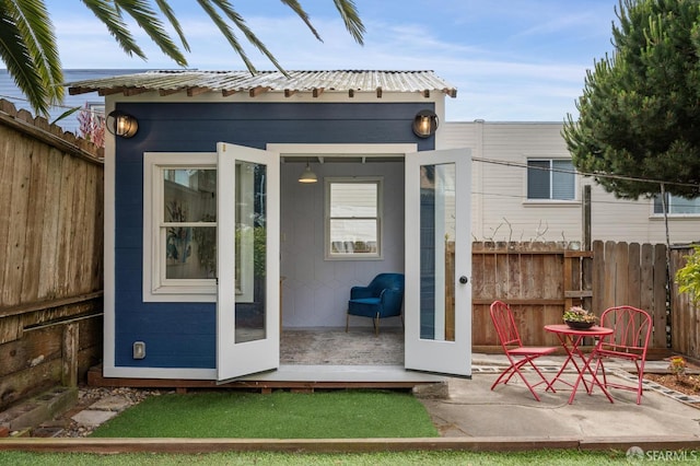 1371-1373 16th Ave, San Francisco, CA 94122 - rear view of property with an outbuilding, a metal roof, and a patio area