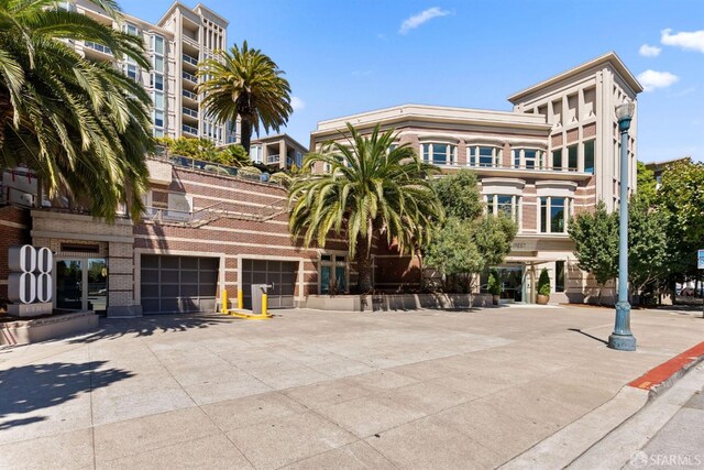 88 King St Unit 104, San Francisco, CA 94107 - view of building exterior featuring an attached garage and concrete driveway