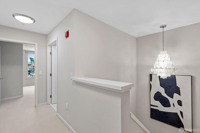 88 King St Unit 104, San Francisco, CA 94107 - hall featuring baseboards, an upstairs landing, carpet, and an inviting chandelier