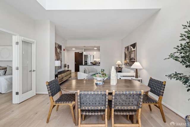 88 King St Unit 104, San Francisco, CA 94107 - dining room with light wood-style flooring, baseboards, and french doors