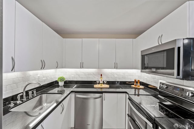 88 King St Unit 104, San Francisco, CA 94107 - kitchen featuring decorative backsplash, white cabinetry, a sink, and appliances with stainless steel finishes