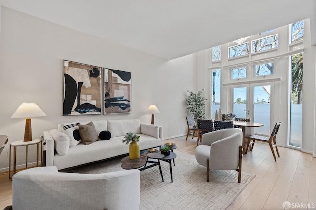 88 King St Unit 104, San Francisco, CA 94107 - living room with a water view, baseboards, and light wood-style floors