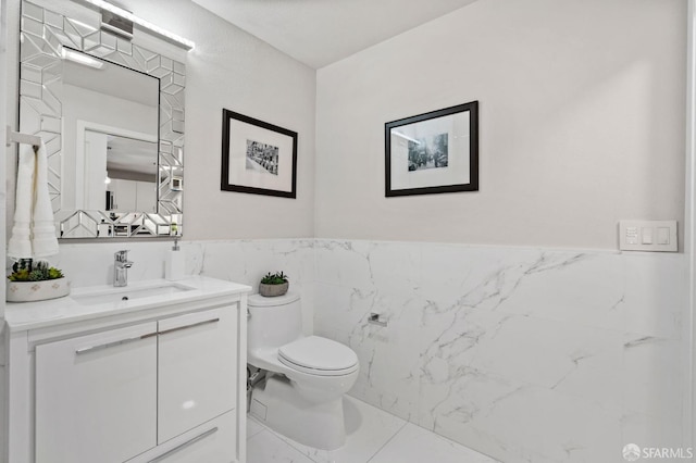 88 King St Unit 104, San Francisco, CA 94107 - bathroom with toilet, vanity, marble finish floor, and tile walls