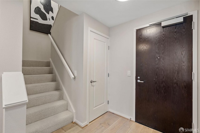 88 King St Unit 104, San Francisco, CA 94107 - foyer entrance with light wood-style floors, baseboards, and stairway