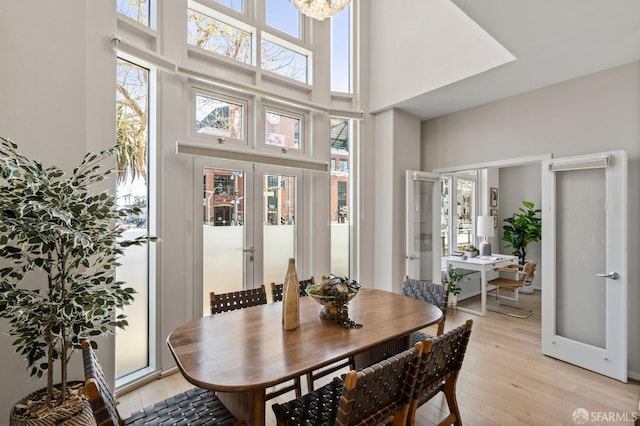 88 King St Unit 104, San Francisco, CA 94107 - dining area with french doors, light wood finished floors, and a high ceiling