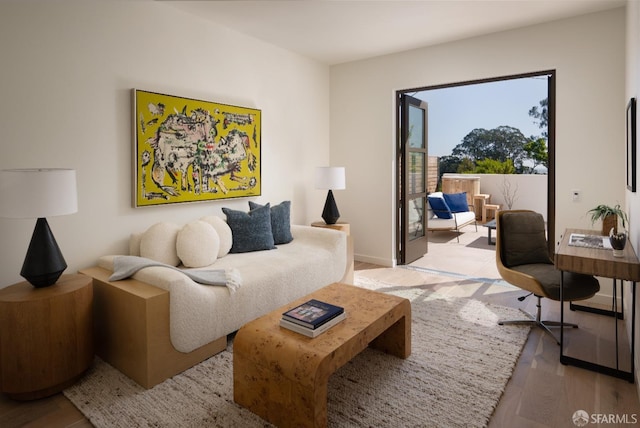 living area with light wood-style floors and baseboards