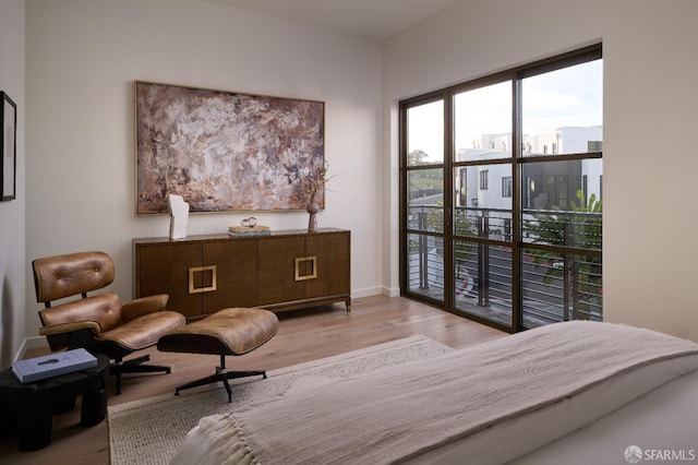 bedroom featuring wood finished floors and baseboards