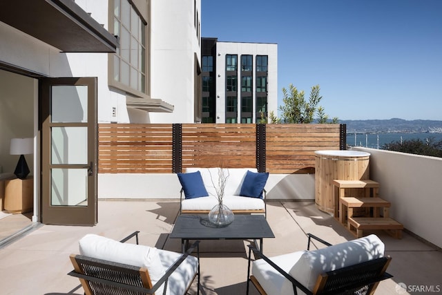 view of patio featuring fence and an outdoor hangout area