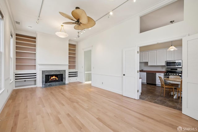 1695 Sutter St, San Francisco, CA 94109 - unfurnished living room with rail lighting, ceiling fan, a high end fireplace, ornamental molding, and built in shelves