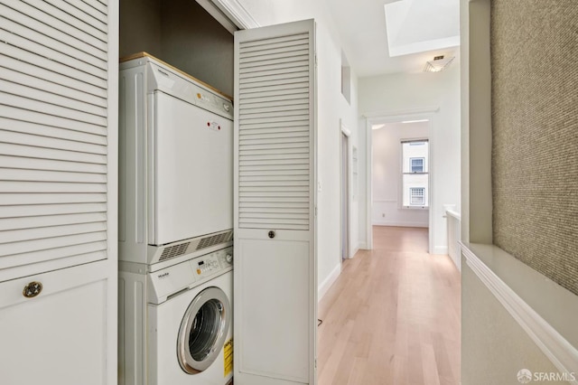 1695 Sutter St, San Francisco, CA 94109 - laundry area with stacked washer and clothes dryer and light wood-style floors