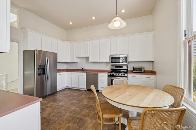 1695 Sutter St, San Francisco, CA 94109 - kitchen with stainless steel appliances, white cabinets, stone finish flooring, pendant lighting, and recessed lighting