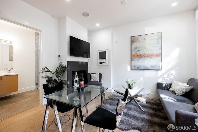 living room with light wood-style flooring, baseboards, and recessed lighting