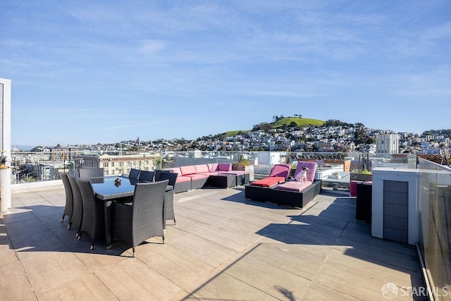 view of patio with outdoor dining area, outdoor lounge area, and a city view